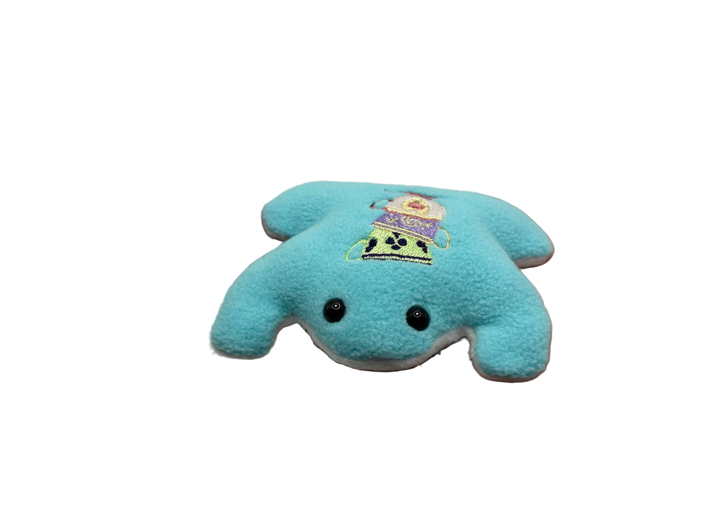 Blue plush toy held in a hand against a white background