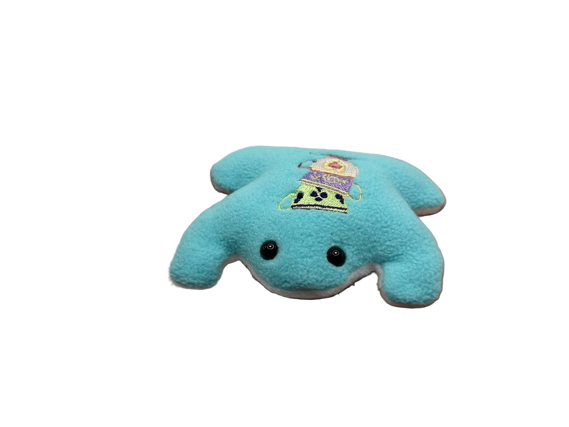 Blue plush toy held in a hand against a white background
