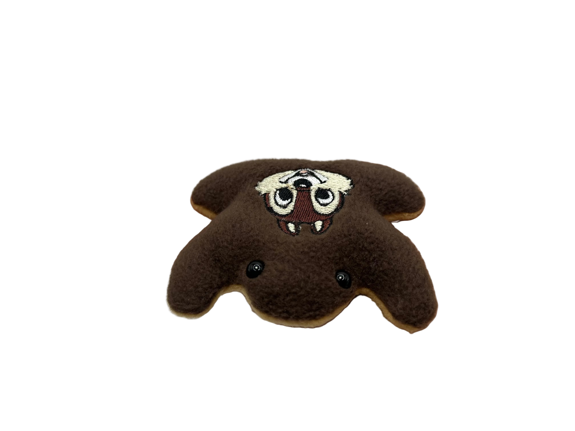 Hand holding a brown plush toy with a face design against a white background